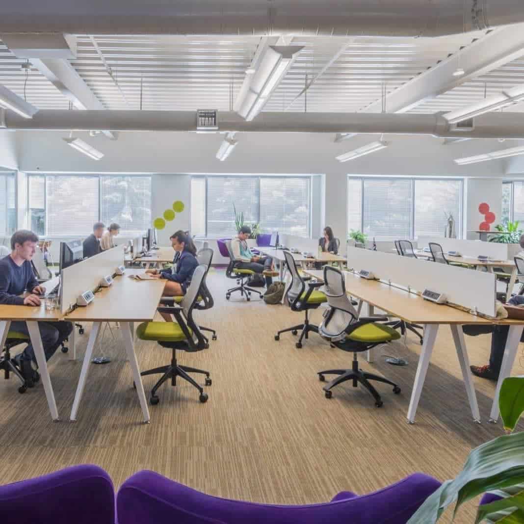 Image of our coworking area with several people working hard on their work.